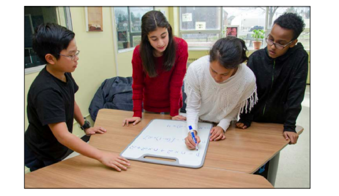 students solving a mathematical problem with numbers and symbols on a small whiteboard.